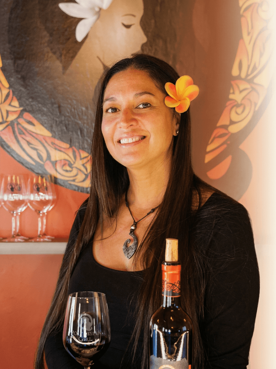 Tatiana at the tasting room with Polynesian Girl wines and the mural